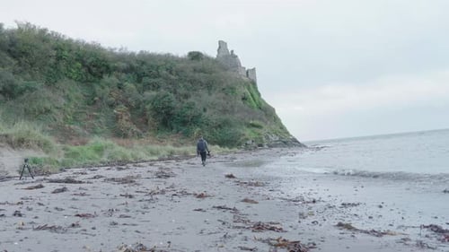 A Videographer near the sea shore on location
