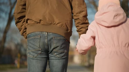 Playful Park Walk Father and Daughter Jumping Joyfully