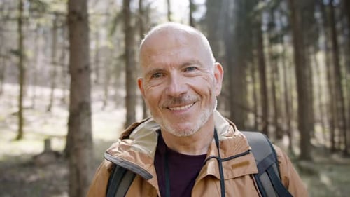 Senior Man Hiker Outdoors Walking in Forest in Nature, Standing and Looking