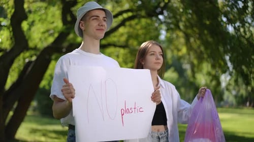 Protest Say No to Plastic A Guy and a Girl Stand Motionless on a Summer Day in a City Park The Guy