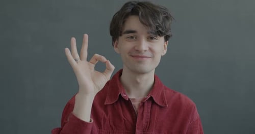 Smiling Man Gives Ok Sign Close Up