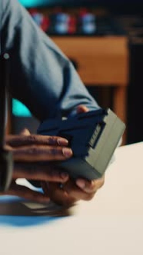Person Showing Camera Battery in Video Recording