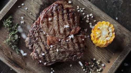 a restaurant guest is salting a steak