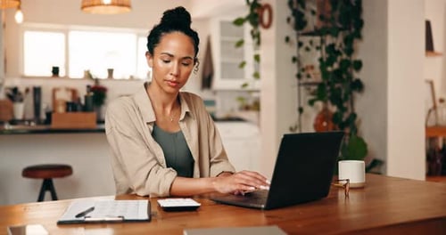 Focused Woman Working from Home on Laptop