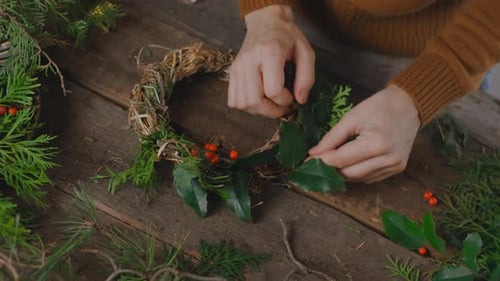 Hands Creating Festive Christmas Wreath