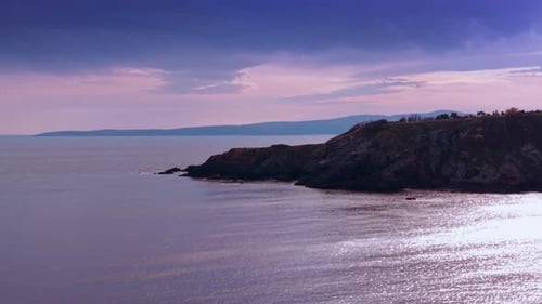 Rocky shore with unapproachable slopes cutting into the waterscape.