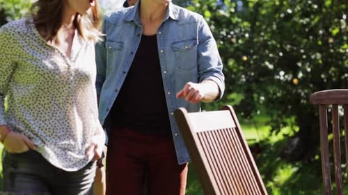 Leisure, Party, People And Holidays Concept - Happy Friends Gathering For Dinner At Summer Garden