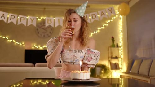 Woman Celebrates Birthday with Cake and Champagne
