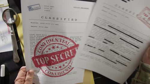 Man Examines Top Secret Classified Military Documents