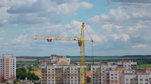 Moving Crane In The City. Field At The Background. Sunny Day. Construction Site