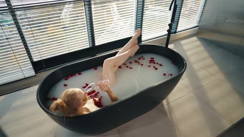 Woman Enjoys Luxurious Milk Bath with Rose Petals