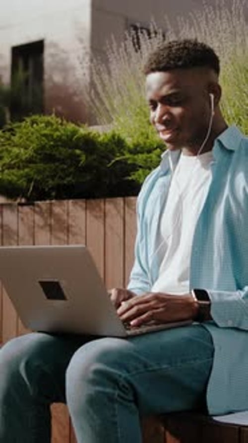 Man Video Conferencing on Laptop Outdoors
