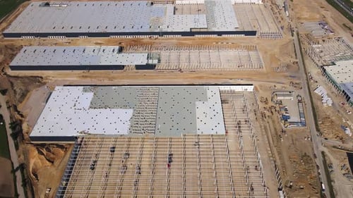 Construction Site with Steel Frame Structure of Warehouse Building Aerial View