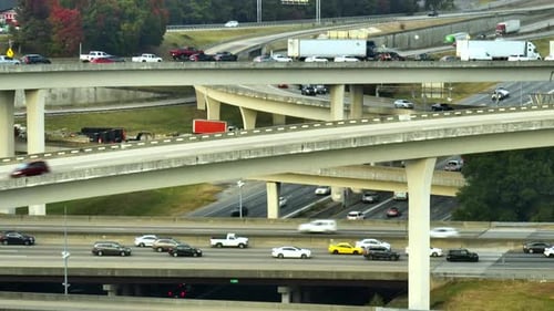 Aerial View of American Freeway Intersection with Fast Moving Cars and Trucks USA Transportation