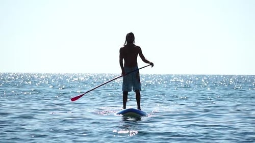 Man Sup Sea Strong Athletic Man Learns to Paddle Sup Standing on Board in Open Sea Ocean on Sunny