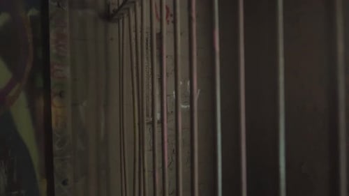 Push-in View Of Old And Rusty Abandoned Prison Cell With A Tagged Smiley On The Wall. - Dynamic Shot