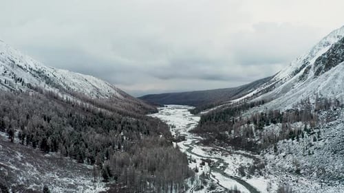 Aerial view of snow-covered mountains and river, Russia.