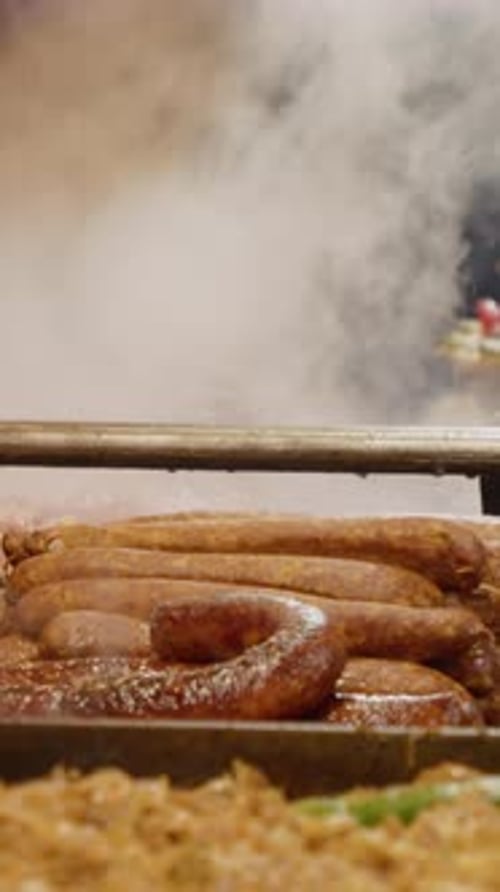 Vertical video Steaming sausages and sauerkraut at street food market