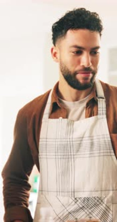 Man Preparing Food in Kitchen with Apron