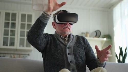 Senior Man Experiencing Virtual Reality in Home