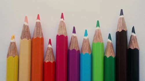 Brightly Colored Pencils Aligned on White Background