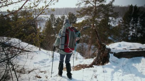 Woman Enjoying Winter Hike in Mountains