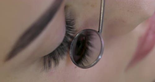 Extreme Close Up of Long Eyelashes and Mirror