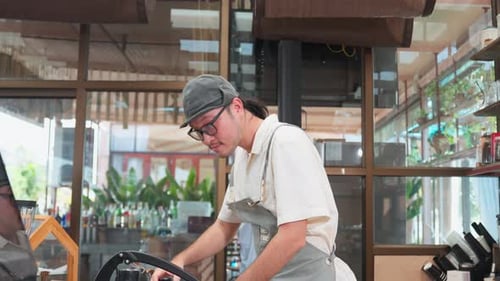 Smiling Barista Behind Coffee Machine in Shop
