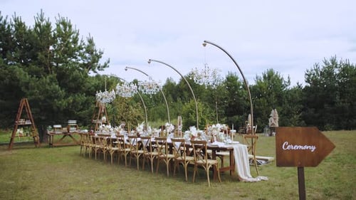 Wedding Reception Table Outdoors with Chandeliers and Decor