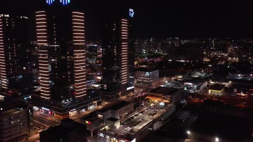 Aerial downward shot of illuminated residential buildings in city at night - Drone shot of city at n