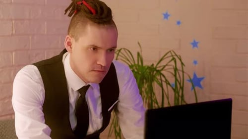 Young Adult Working on Laptop at Home