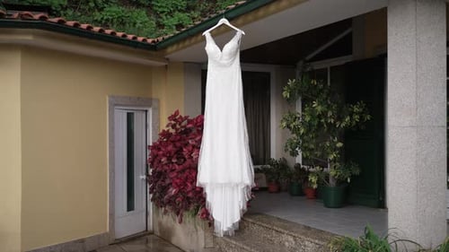Elegant Wedding Dress Hanging Outside Home