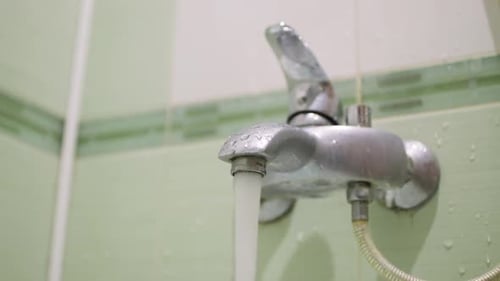 Running Water Flows From Silver Bathroom Faucet