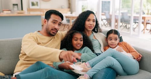 Family Togetherness on Couch Watching Entertainment at Home
