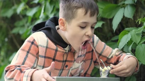Boy Opts for Fountain Water Over Bottled a Potent Symbol of Environmental Care His Choice Reduces