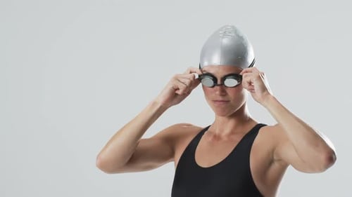 Woman Adjusting Swimming Goggles and Cap