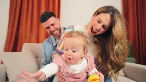 Happy Family with Baby Playing with Toys