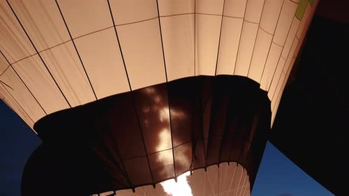 Flame Illuminates Hot Air Balloon at Night