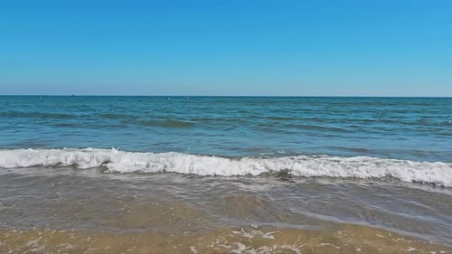Calm Weather on a Sunny Day Small Waves Arrive at the Shore The End or Beginning of the Swimming
