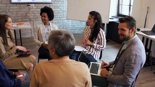 Group of diverse business people having a meeting while sitting in circle.