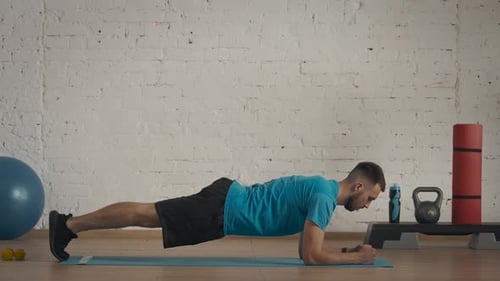 Young Adult Man Doing Plank Exercise at Home