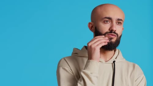 Man Thinking, Beard Stroking, on Blue Background