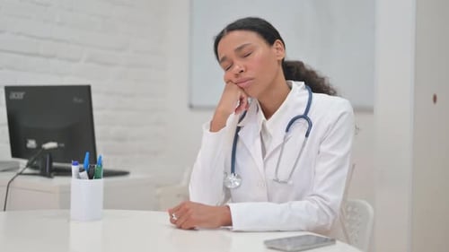African Female Doctor Sleeping while sitting in Clinic