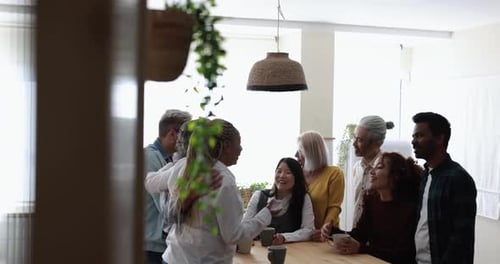 Diverse Group Chatting Around Table at Home