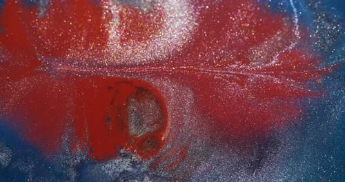 Abstract Liquid Glitter Flowing in Red Blue White