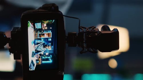 Camera Recording Man Working at Desk at Night