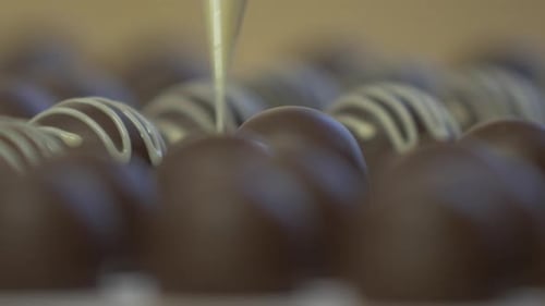 decorating chocolates with white garnish