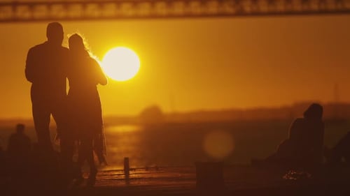 Romantic Couple Dancing on Pier at Sunset