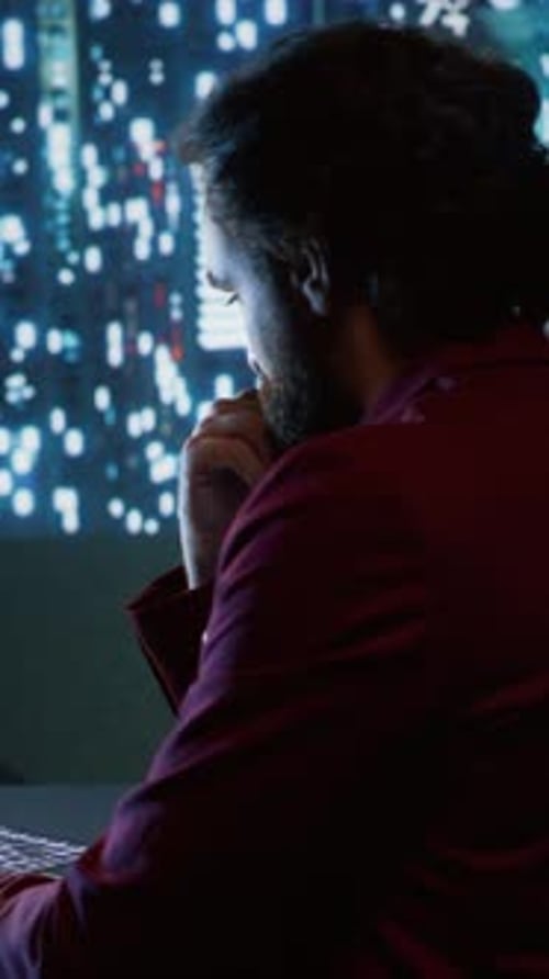 Man Working on Computer at Night