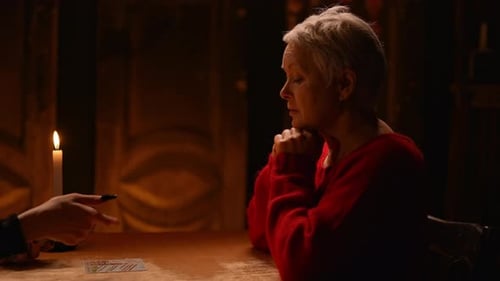 Senior Woman Receiving Tarot Reading by Candlelight